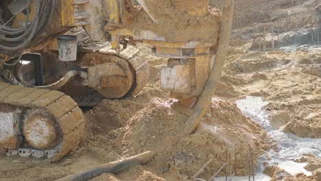 equipment for installing piles in ground, heavy machines for driving pillars work in laying the foundation building. construction aerial view height. construction site drilling pile foundation.