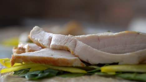 juicy slices of grilled chicken breast steaming on bed of spinach and yellow pepper