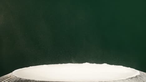 jumping flour on moving subwoofer on green background