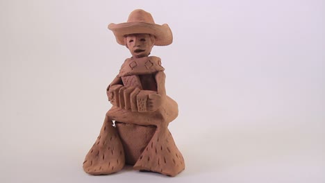 the musician plays the accordion. small ceramic sculpture-1