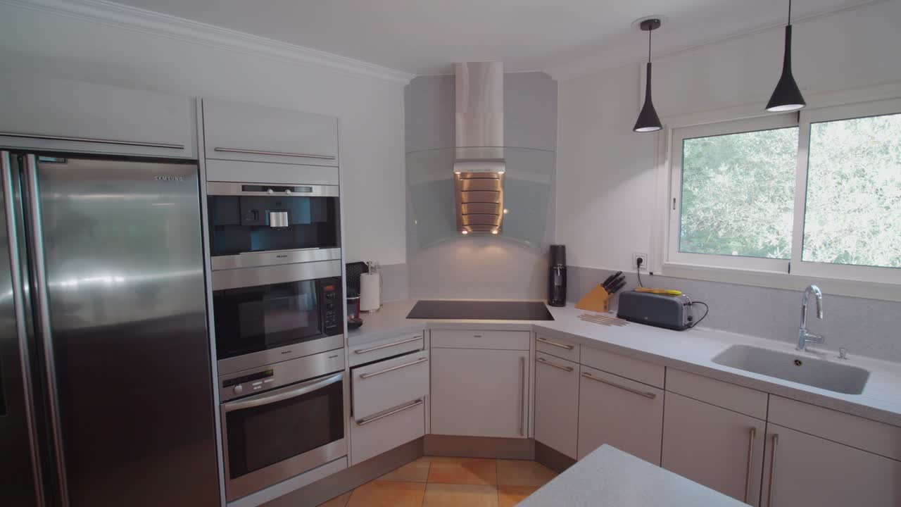Tomada de afastamento lenta de uma cozinha moderna com um grande balcão de café da manhã e frutas frescas
