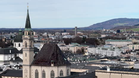 tower and roof of franciscan church on sunny day in salzburg, austria. static shot