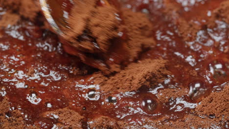 mixing chocolate powder into a sauce
