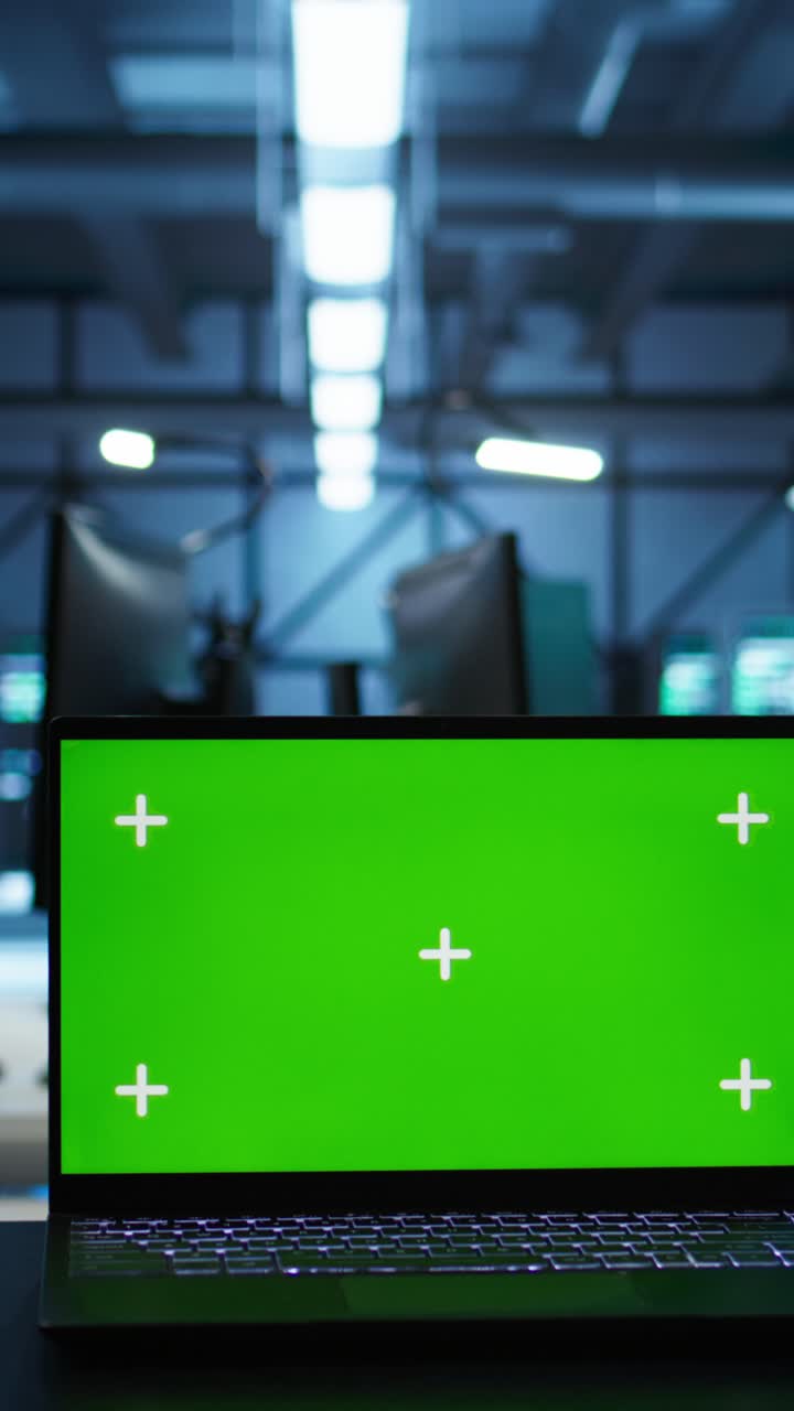Laptop with Green Screen Display in Modern Office