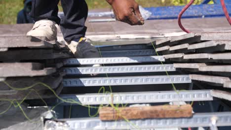 asian worker doing roof installation on site, close up