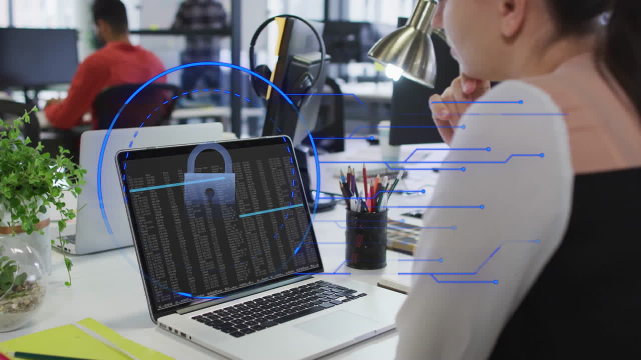 Person at desk viewing cybersecurity animation over laptop screen with lock symbol