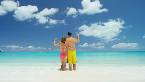 caucasian couple in swimwear on luxury beach vacation