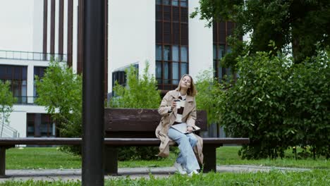 woman drinking coffee in a park