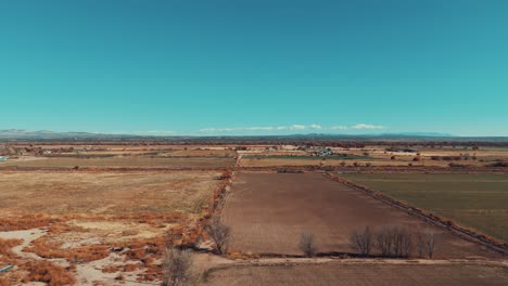 Flying-over-open-farmland-field