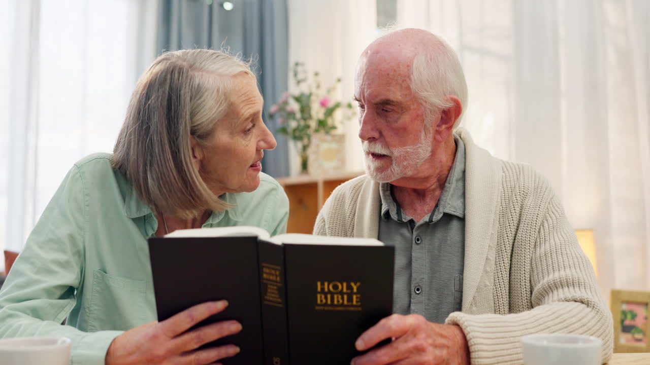 Elderly couple reading the bible together