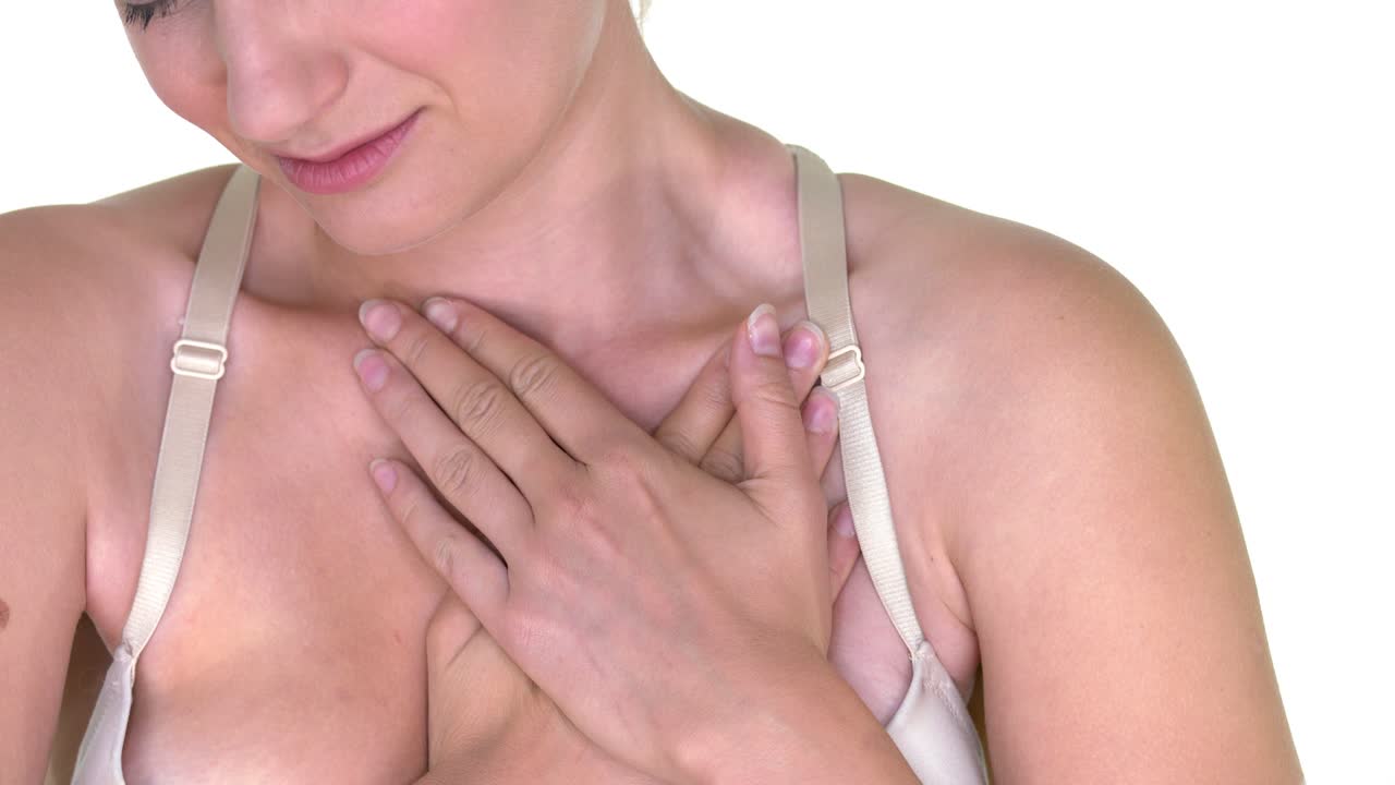 The woman experiences severe chest pain. The concept of a heart attack and heart disease. Close up of the chest