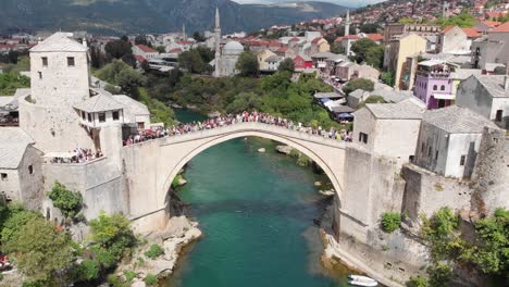 aerial: drone flying on front of the stari most in mostar in a partially sunny day. drone circular movement