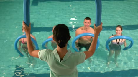 fit group doing aerobical excercises in the pool