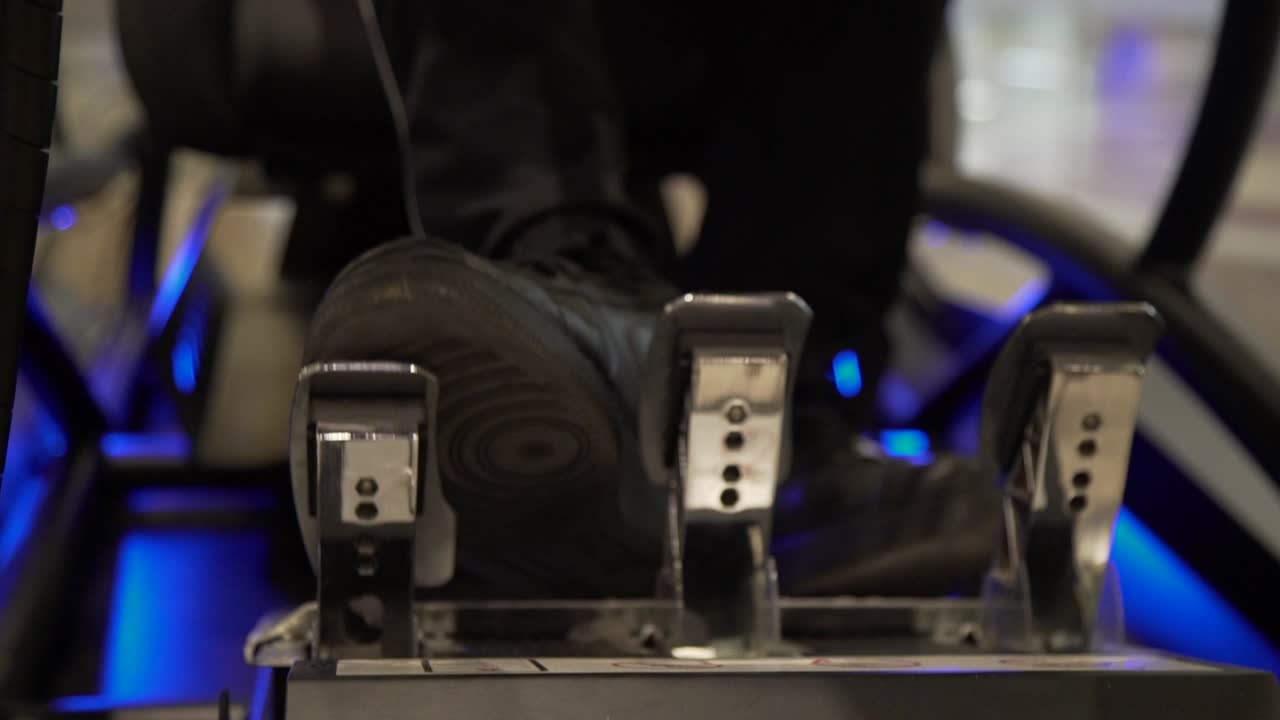 cerca de los pies en los pedales de la cabina de un simulador de carreras