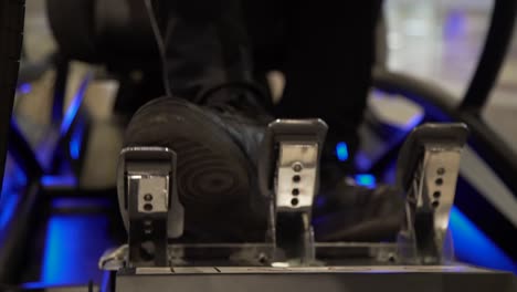 close up of feet in the pedals of a racing simulator cockpit