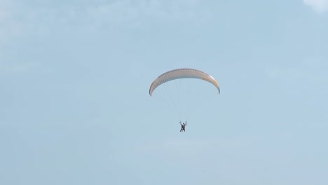tourists fly on parachute in sky at resort slow motion