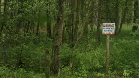 Static-wide-shot-of-a-warning-sign-in-the-forest-of-Sankt-Peter-Ording