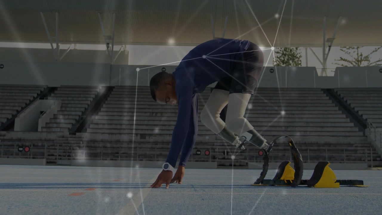Tenåringssprinter som går inn i startblokkene og justerer proteseblader for sprintstart