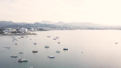 Cinematic-drone-footage-of-Sant-Antoni-de-Portmany-sea-bay-with-sailboats