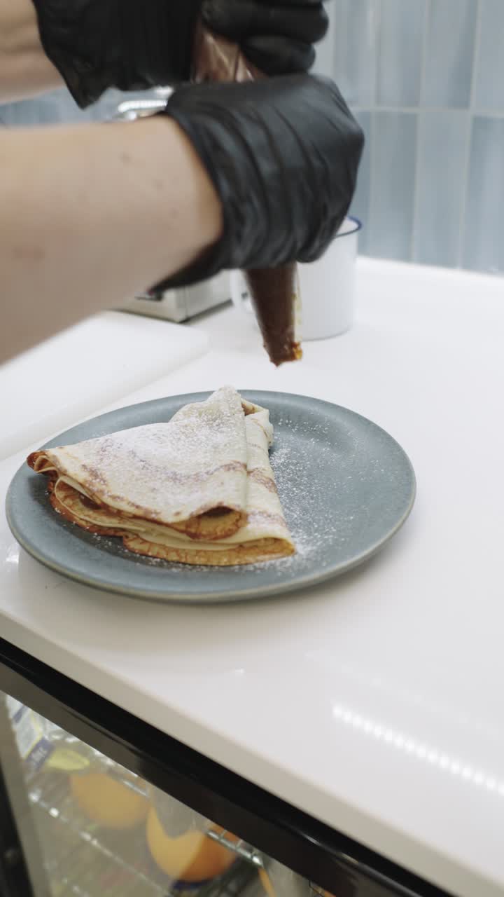 Pancakes with chocolate and powdered sugar