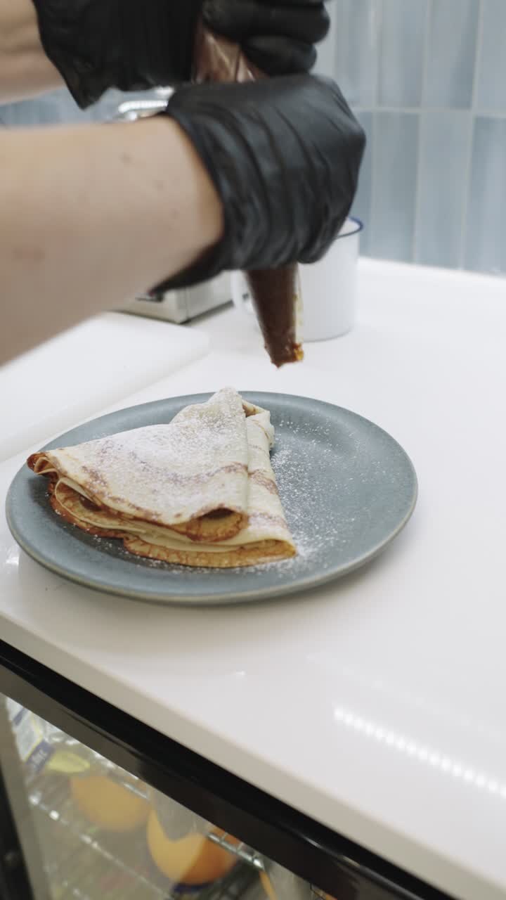 Pancakes with chocolate and powdered sugar