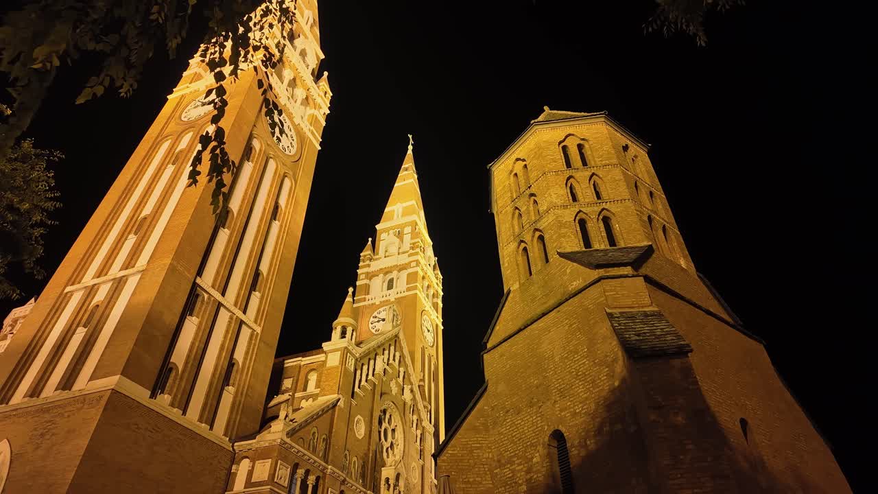 The magnificent building and tower of the Szeged Cathedral from the side at night in Hungary