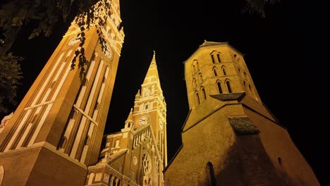 the magnificent building and tower of the szeged cathedral from the side at night in hungary