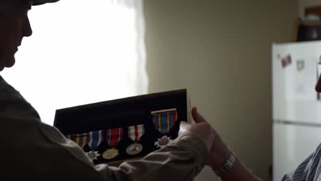 honoring valor: a heartfelt exchange between two generations as medals of honor are relived and cherished in this intimate moment of remembrance