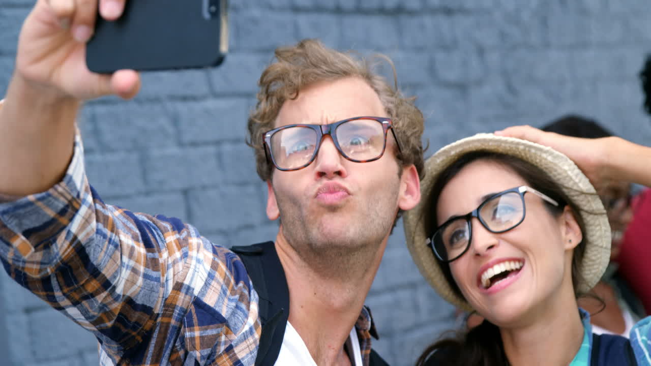 Young hipsters are taking a selfie 