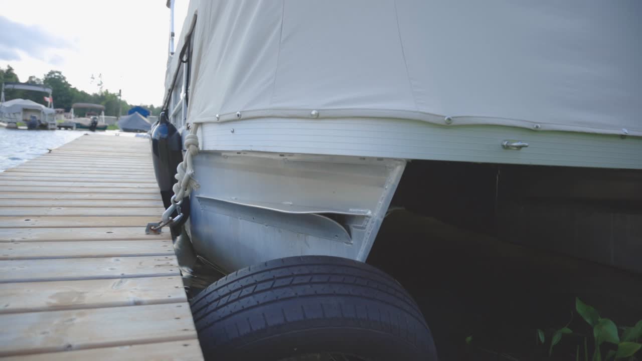 Hull Of Boat Anchored On The Wooden Jetty During Summer. - close up shot