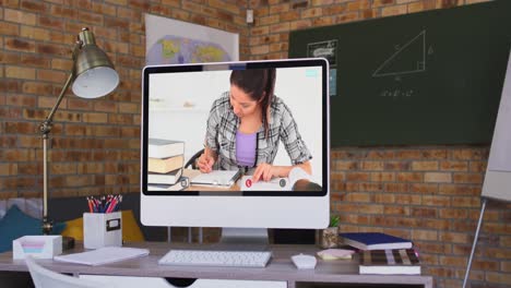 Caucasian-female-student-displayed-on-computer-screen-during-video-call