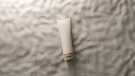white cream tube on wrinkled fabric