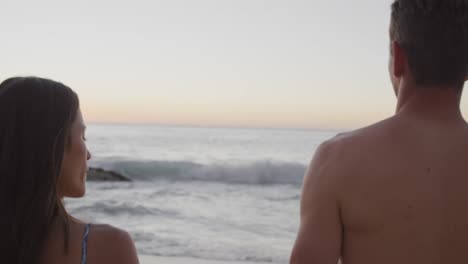 Young-adult-couple-relaxing-at-the-seaside