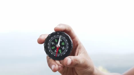 hand holding a compass for travel.
