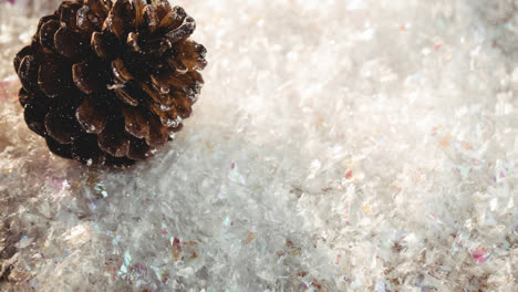 animation of snow falling over pine cones on snow