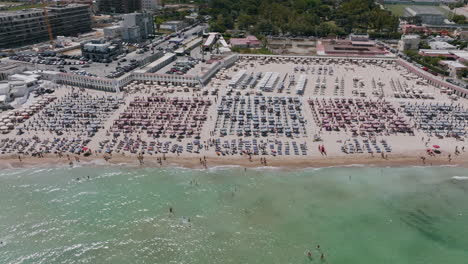 aerial footage of a resort and people at the beach in bari, italy during the day