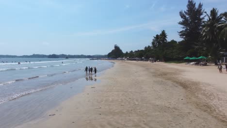 flying low under volleyball net on weligama wide beach and calm sea, sri lanka