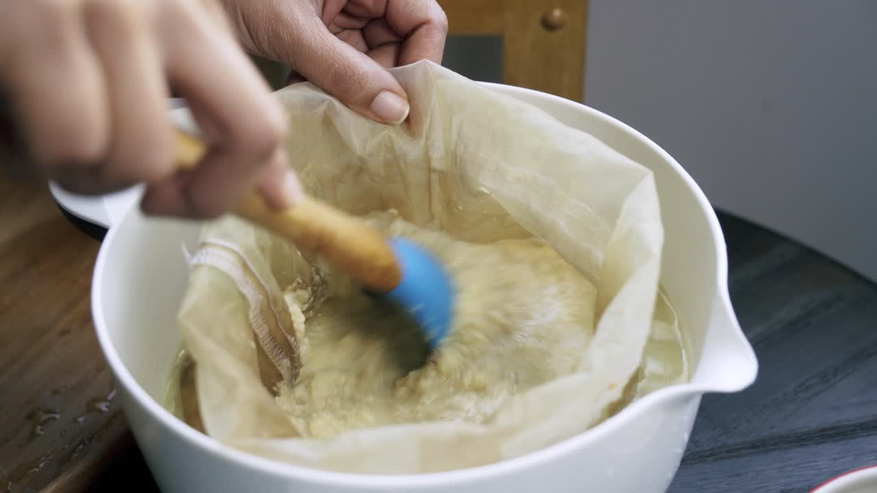 Mixing a nut bag full of blended ginger pulp homemade juicing healthy vegan eating fresh organic