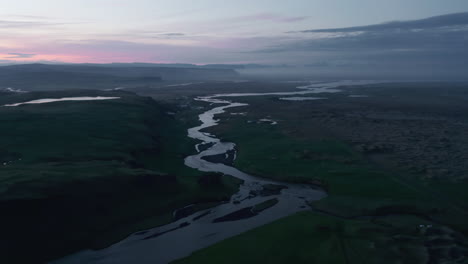 Aerial-view-of-Throsmork-national-park-with-Krossa-river-flowing-riverbed-at-sunset.-Birds-eye-of-desolate-and-lonely-landscape-of-Porsmork-with-green-countryside-in-Iceland.-Amazing-in-nature