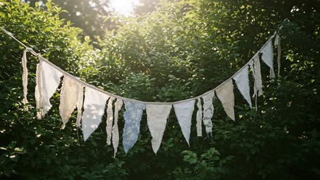 a captivating display of fabric banners gently draped among lush greenery, creating a whimsical atmosphere in a natural setting perfect for celebrations