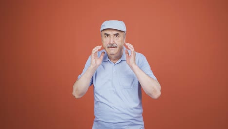 fear reaction of old man looking at camera. coward old man.