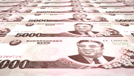 banknotes of five thousand wons of north korea rolling, cash money, loop