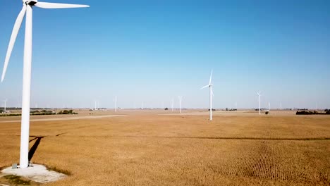 spinning wind turbines generating energy - electricity - aerial establishing drone view