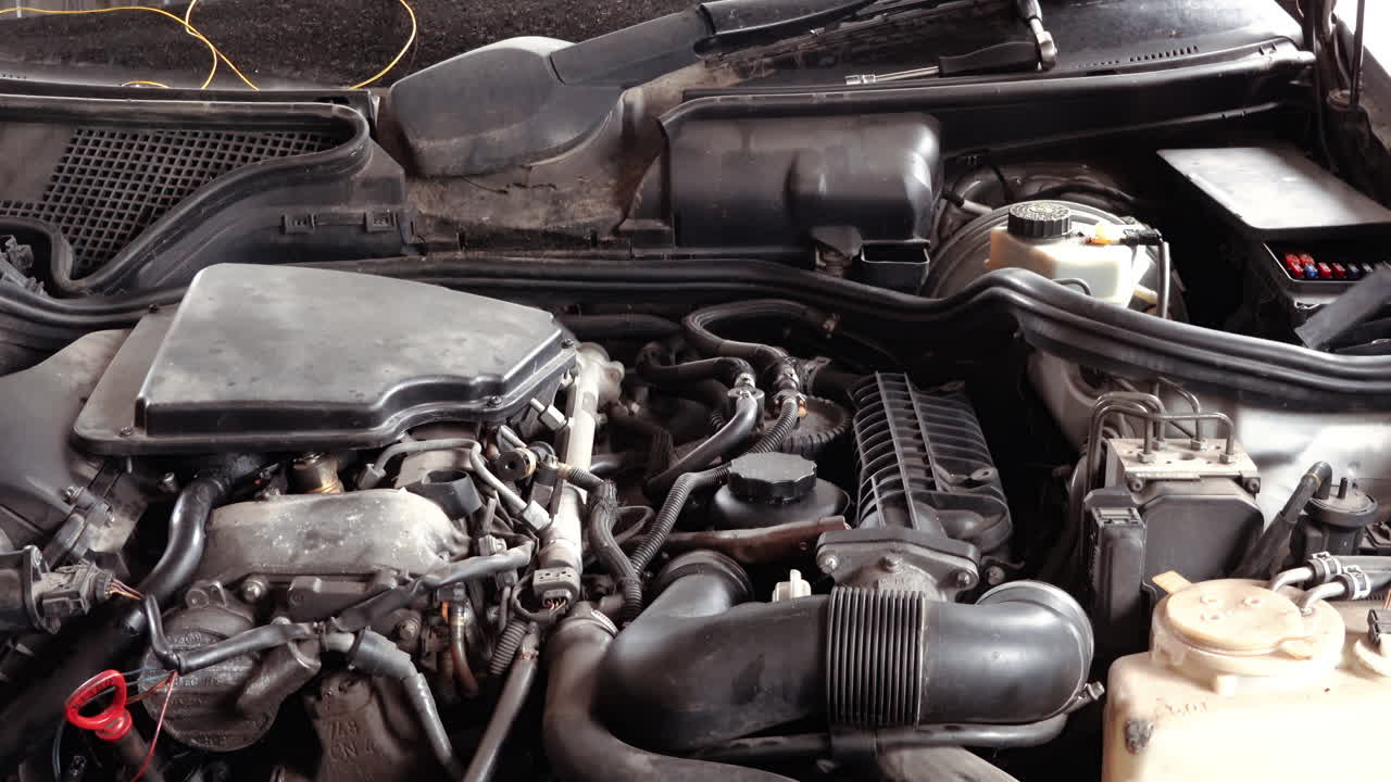 Man working on the engine bay of a car