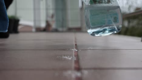 Woman-cleaning-tile-floors-outdoors,-spring-cleaning