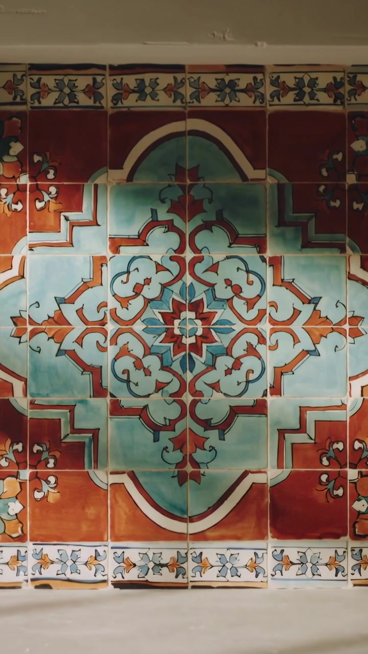 Vertical video: Shifting sunlight crossing ceramic tile medallion at kitchen ledge, revealing glaze