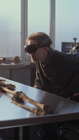 researcher examining ancient remains with vr headset