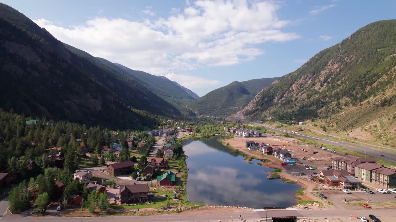 This is an aerial video of the town of Georgetown Colorado. The camera rises and advances revealing Georgetown Lake and the city of Georgetown .