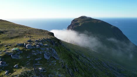 Cloud-moves-over-Ryten-Mountain-Trail-in-Lofoten-Islands,-Norway---Pan-Left