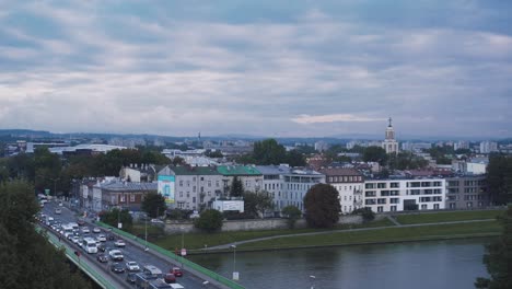 wawel castle in the background with some gardens and a cloudy sky in krakow